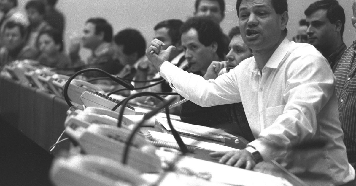 Stock broker giving a purchase order on the trading floor, illustrating premium brokerage services
